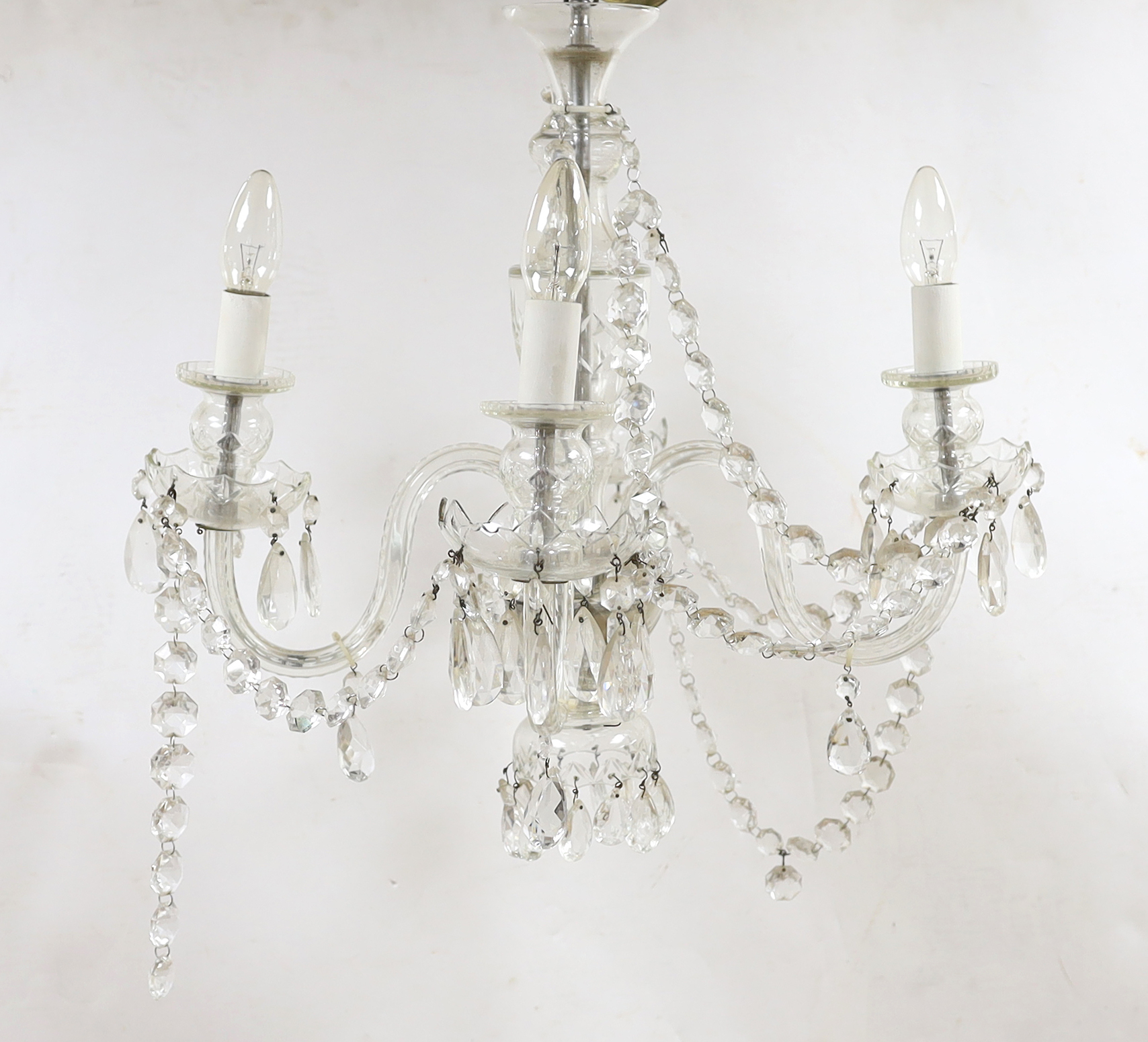 A glass four branch chandelier with hanging drops, 59cm high